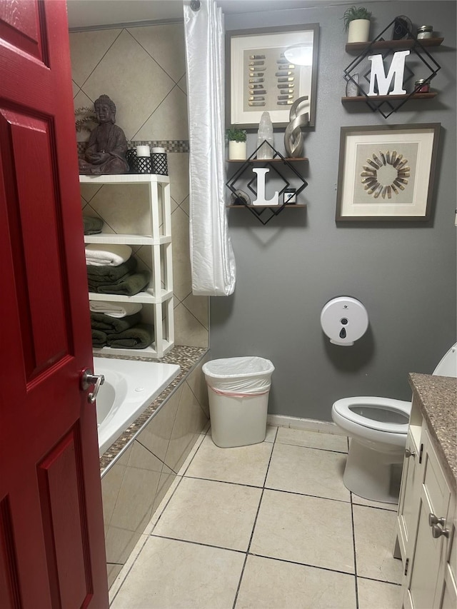 bathroom featuring tile patterned floors, toilet, vanity, and tiled shower