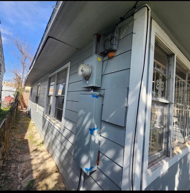 view of side of property featuring fence
