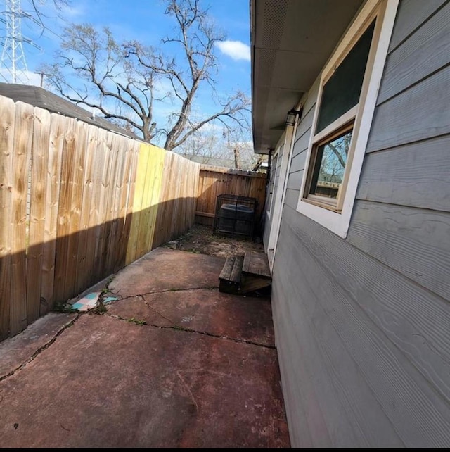 view of property exterior featuring a fenced backyard and a patio