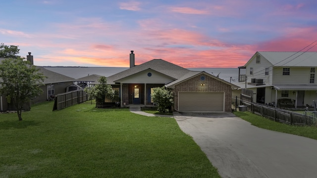 200 Little Dove, Livingston, TX 77351 - view of front of property with brick siding, concrete driveway, an attached garage, central air condition unit, and a chimney