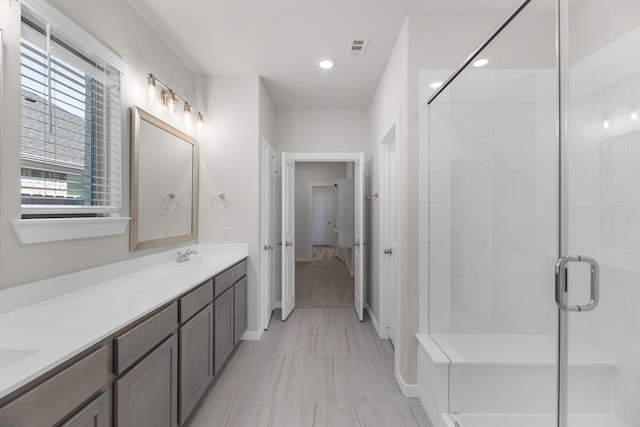 21624 Alberta Forest Cir, Magnolia, TX 77355 - bathroom with baseboards, double vanity, recessed lighting, a shower stall, and visible vents
