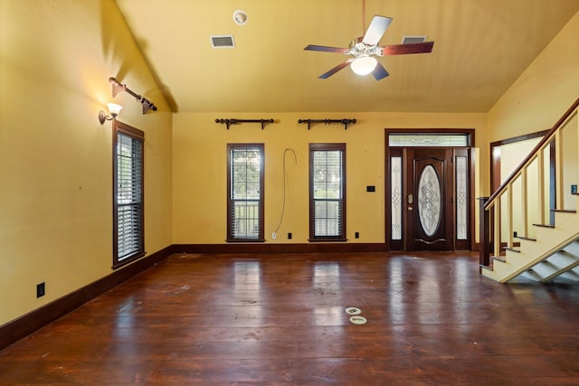foyer entrance featuring visible vents, lofted ceiling, a healthy amount of sunlight, and hardwood / wood-style floors