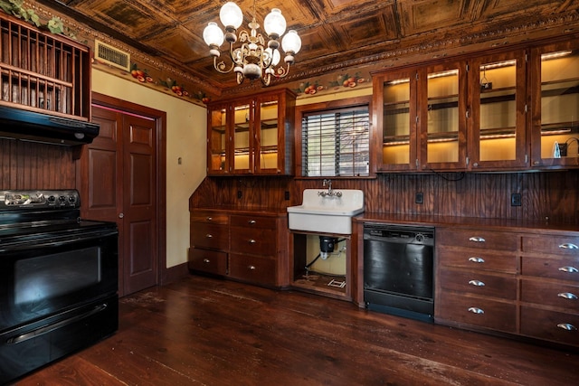 interior space with dark wood-style floors, under cabinet range hood, visible vents, an ornate ceiling, and black appliances
