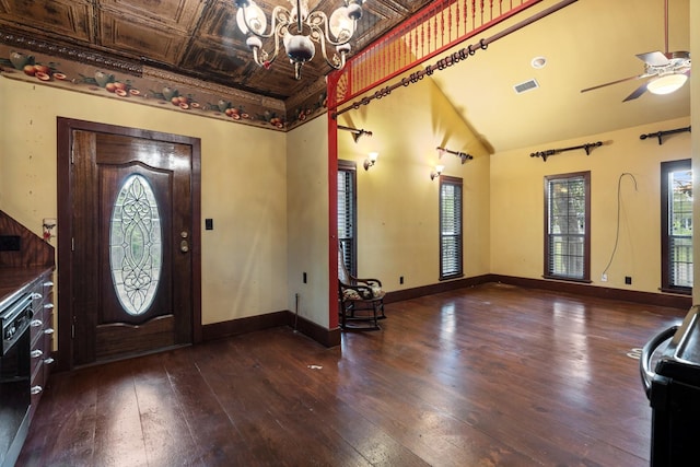 entrance foyer featuring visible vents, baseboards, ceiling fan with notable chandelier, an ornate ceiling, and hardwood / wood-style floors