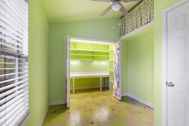 unfurnished bedroom with baseboards, a ceiling fan, and wood finished floors