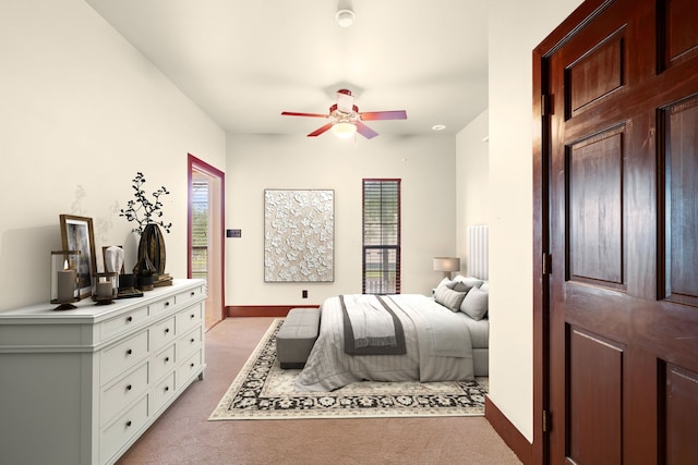 bedroom with light colored carpet, baseboards, and access to outside