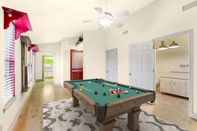 rec room with lofted ceiling, visible vents, and light wood-style floors