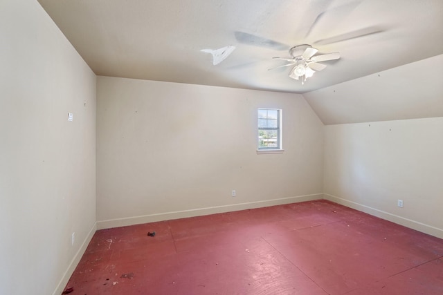 additional living space featuring baseboards, a ceiling fan, and lofted ceiling