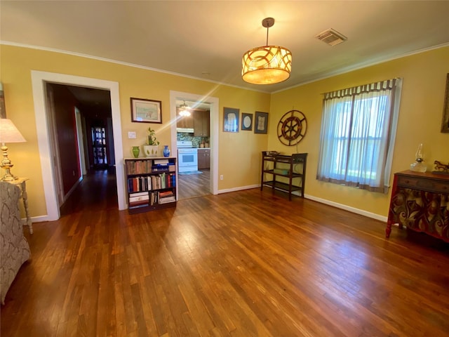 2027 103rd St, Galveston, TX 77554 - dining area featuring visible vents, baseboards, crown molding, and wood finished floors