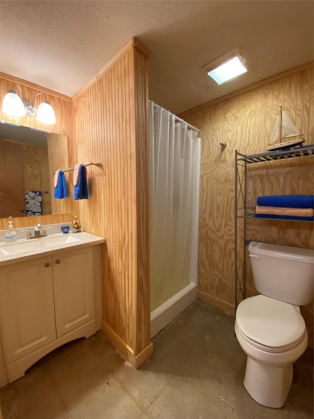 2027 103rd St, Galveston, TX 77554 - bathroom featuring toilet, baseboards, concrete flooring, curtained shower, and vanity