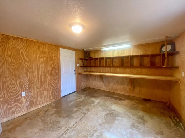 2027 103rd St, Galveston, TX 77554 - finished below grade area with a textured ceiling and wooden walls