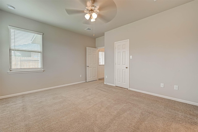 spare room featuring ceiling fan, baseboards, carpet flooring, and visible vents