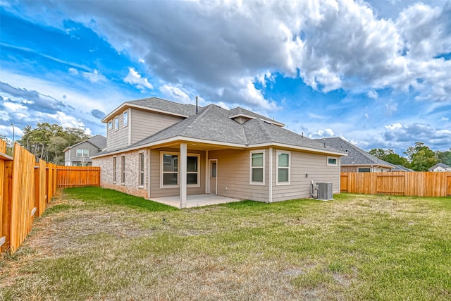 rear view of property with a patio, central AC unit, a yard, and a fenced backyard
