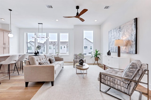 living room featuring recessed lighting, light wood finished floors, visible vents, and a ceiling fan
