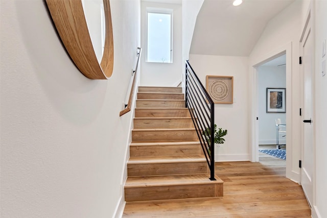stairs with recessed lighting, baseboards, vaulted ceiling, and wood finished floors