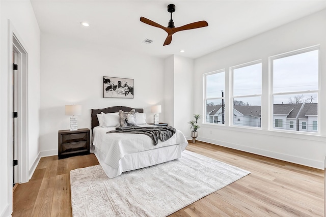 bedroom featuring visible vents, baseboards, light wood-type flooring, and recessed lighting