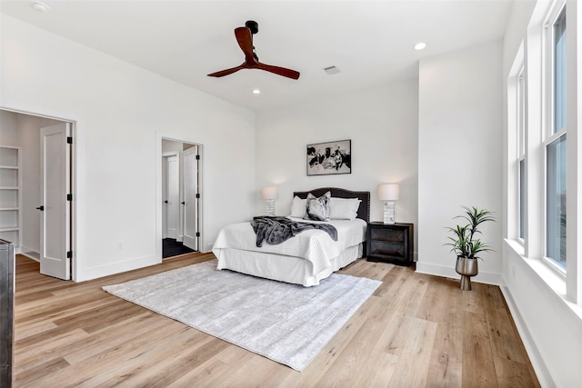 bedroom with light wood-type flooring, baseboards, visible vents, and recessed lighting