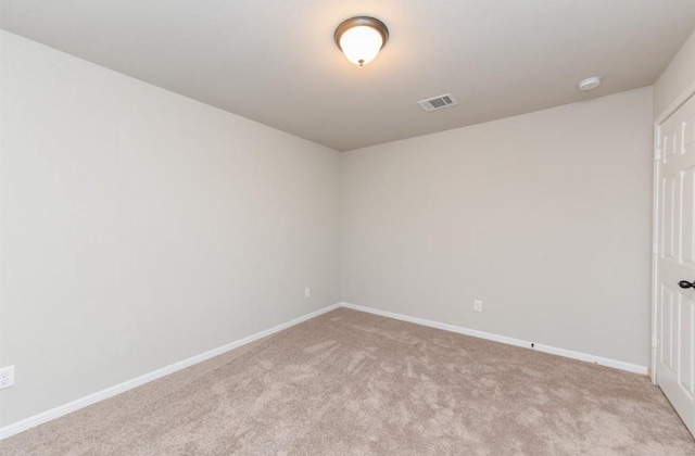 spare room featuring visible vents, baseboards, and carpet floors