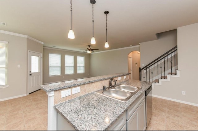 kitchen featuring a ceiling fan, crown molding, stainless steel dishwasher, arched walkways, and a sink