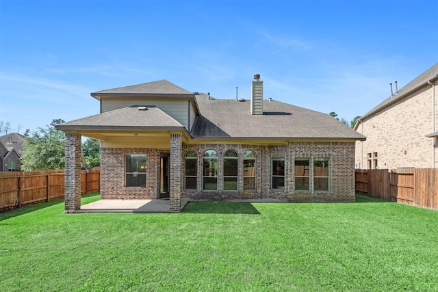 1715 Laremont Bend Dr, Spring, TX 77386 - back of property featuring brick siding, a patio, a chimney, and a shingled roof