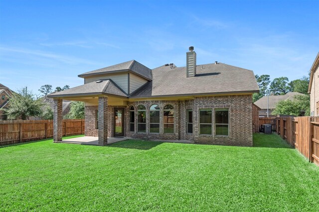 1715 Laremont Bend Dr, Spring, TX 77386 - rear view of house with brick siding, a chimney, a patio, central AC unit, and a shingled roof