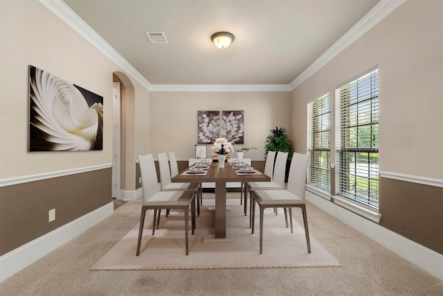 1715 Laremont Bend Dr, Spring, TX 77386 - carpeted dining room featuring ornamental molding, arched walkways, and baseboards
