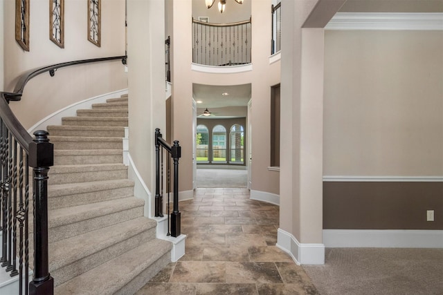 1715 Laremont Bend Dr, Spring, TX 77386 - entryway featuring baseboards, stairway, stone finish flooring, and a towering ceiling