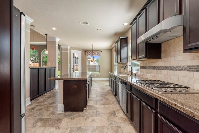 1715 Laremont Bend Dr, Spring, TX 77386 - kitchen featuring appliances with stainless steel finishes, exhaust hood, a center island, baseboards, and tasteful backsplash