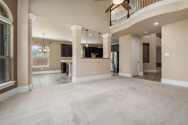1715 Laremont Bend Dr, Spring, TX 77386 - unfurnished living room with light carpet, a ceiling fan, a chandelier, baseboards, and a high ceiling