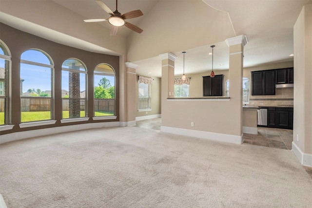 1715 Laremont Bend Dr, Spring, TX 77386 - unfurnished living room with light carpet, baseboards, ornate columns, ceiling fan, and vaulted ceiling