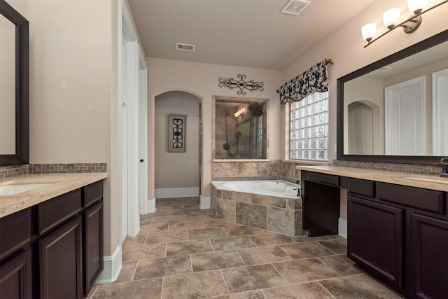 1715 Laremont Bend Dr, Spring, TX 77386 - full bath featuring two vanities, a bath, baseboards, a tile shower, and decorative backsplash