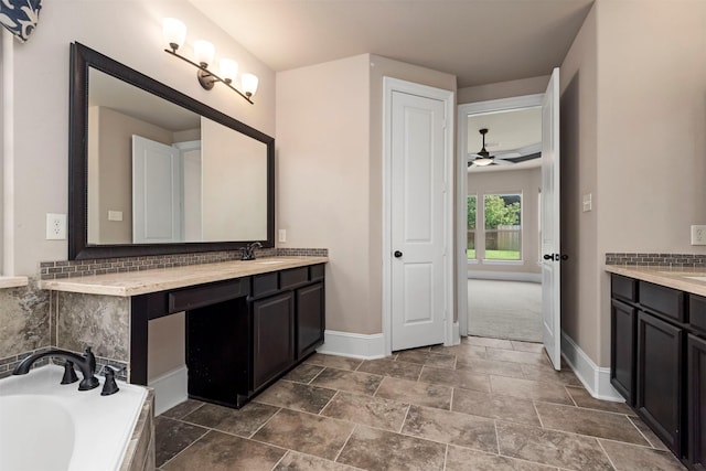 1715 Laremont Bend Dr, Spring, TX 77386 - full bath featuring baseboards, vanity, a garden tub, and tasteful backsplash