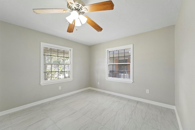 unfurnished room featuring baseboards and a ceiling fan