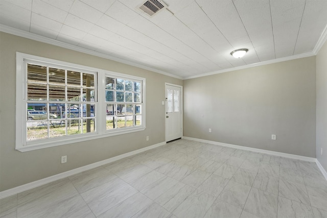 spare room featuring visible vents, baseboards, and crown molding