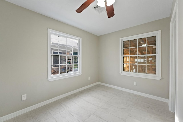 spare room with visible vents, baseboards, and ceiling fan