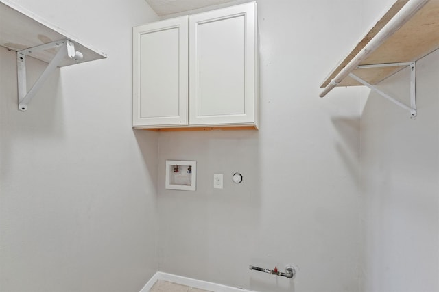 clothes washing area with hookup for a gas dryer, baseboards, hookup for a washing machine, and cabinet space