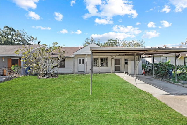 single story home with a front yard, fence, and a carport