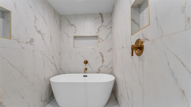 full bath with a freestanding bath and tile walls