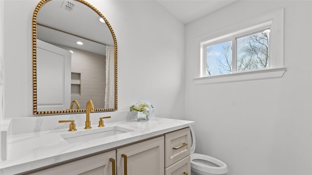 full bath featuring recessed lighting, vanity, visible vents, and toilet