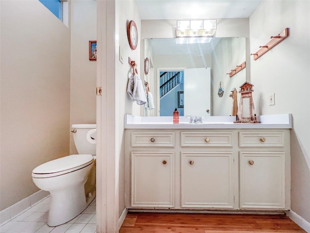 3203 Bayou Dr, La Porte, TX 77571 - half bath with toilet, vanity, baseboards, and wood finished floors