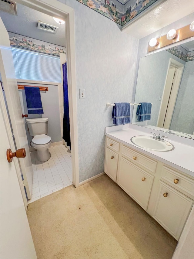 3203 Bayou Dr, La Porte, TX 77571 - bathroom featuring toilet, vanity, tile patterned floors, and baseboards