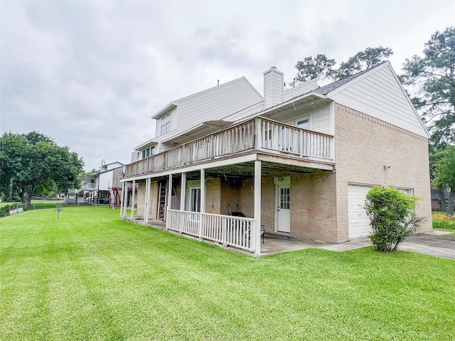 3203 Bayou Dr, La Porte, TX 77571 - rear view of property with a lawn, a garage, a chimney, brick siding, and a wooden deck