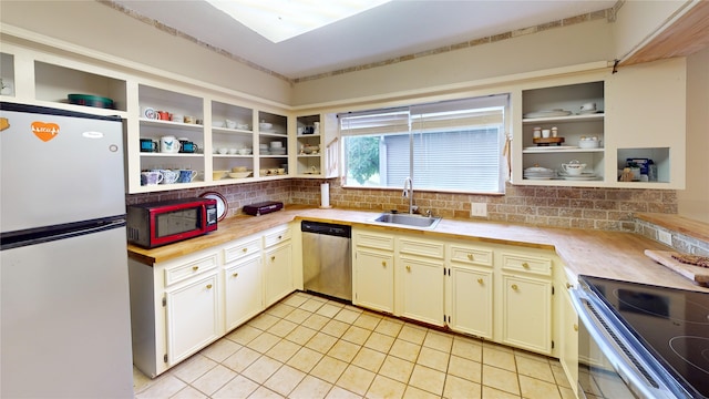 3203 Bayou Dr, La Porte, TX 77571 - kitchen featuring appliances with stainless steel finishes, open shelves, a sink, and light countertops