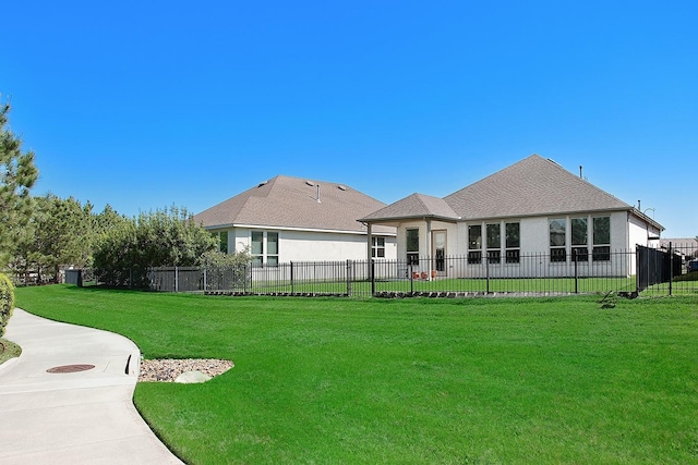 247 Arabian Dr, The Woodlands, TX 77382 - rear view of house with fence, a lawn, and roof with shingles