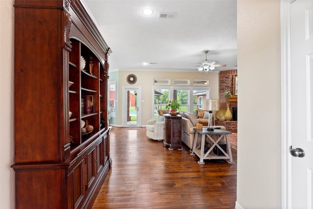 hall with visible vents, crown molding, baseboards, dark wood-style floors, and recessed lighting