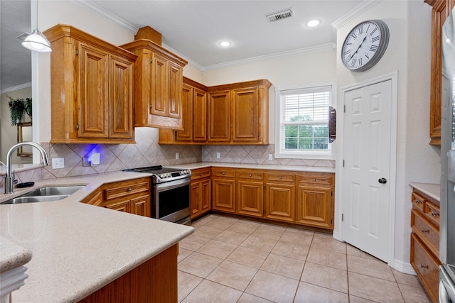 kitchen with brown cabinets, stainless steel range with electric cooktop, a sink, decorative backsplash, and ornamental molding