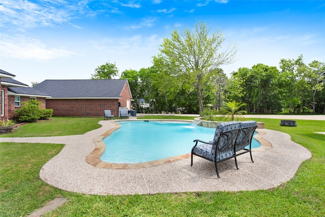 outdoor pool featuring a lawn and a patio