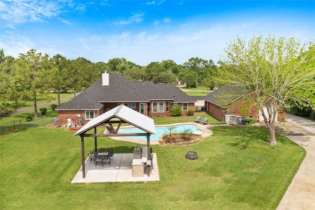 view of swimming pool featuring a lawn, a patio, a gazebo, and fence