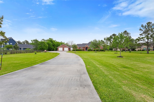 view of front of house featuring a garage, a residential view, and a front yard
