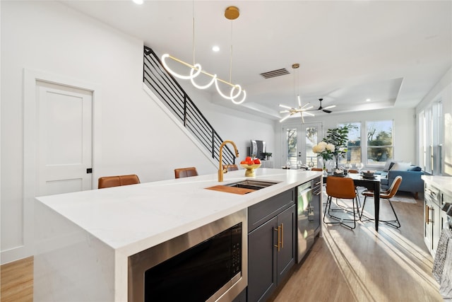 4323 Rogers St, Houston, TX 77022 - kitchen featuring visible vents, a sink, open floor plan, a tray ceiling, and built in microwave